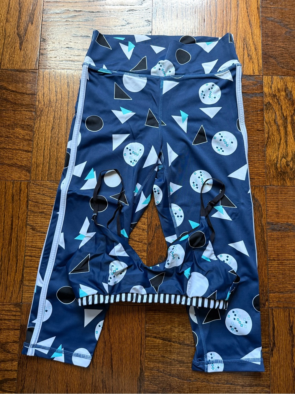 The Upside Navy Geometric Capri Leggings with Teal Accents. A set